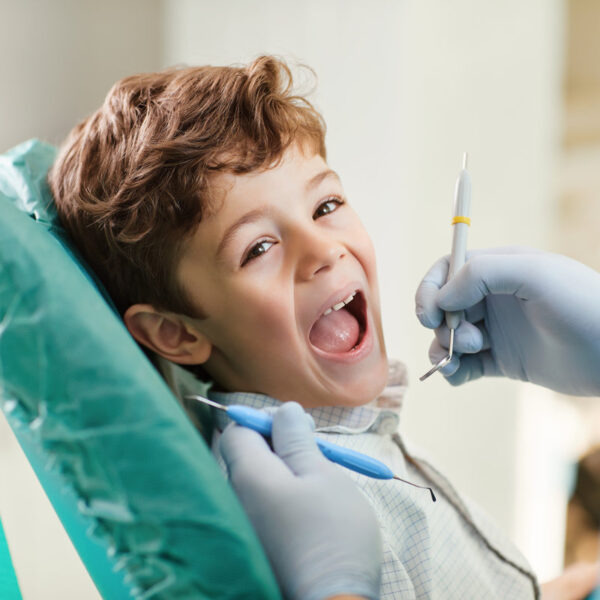 Beautiful child smiling while sitting in the dentist's chair. Close-up.