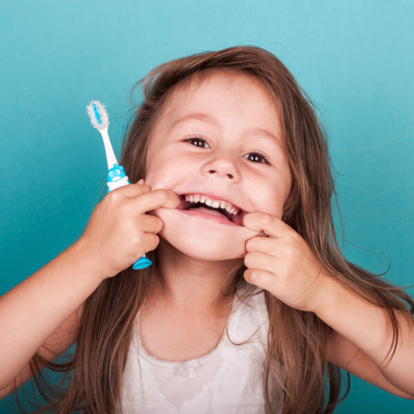 Cute little girl brushing her teeth