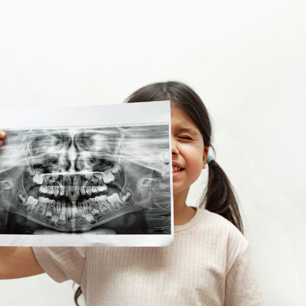 Caucasian Girl with a panoramic shot of teeth and jaw on a white background, close-up, diagnosis