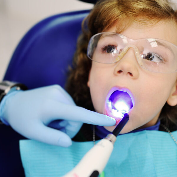 pediatric dentist man makes dental fillings baby boy