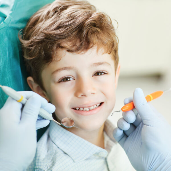 Beautiful child smiling while sitting in the dentist's chair. Close-up.