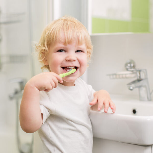 Happy kid brushing teeth