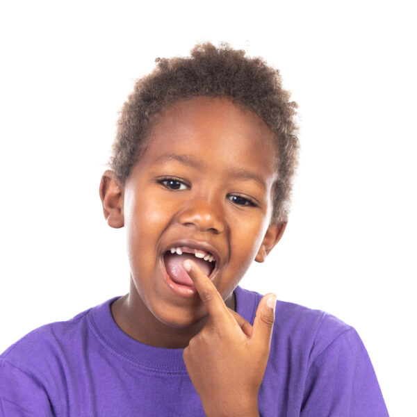 African child showing his new teeth isolated on a white background