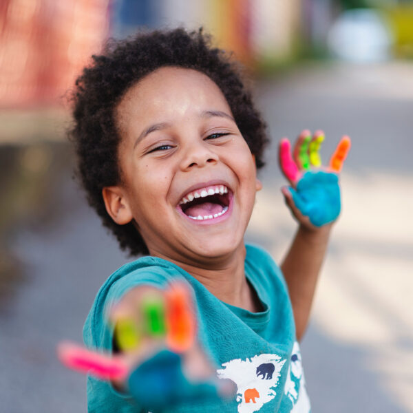 beautiful happy boy with painted hands