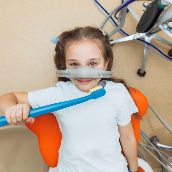 little girl with sedation mask. Treatment of children's teeth with nitrous oxide. children's dentistry.