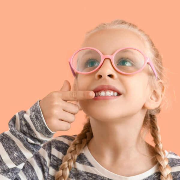 Little girl with healthy teeth on color background with space for text